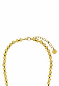 Collar de color dorado con cuentas redondas, un cierre de langosta y una cadena ajustable con una etiqueta circular marcada "STEEL".