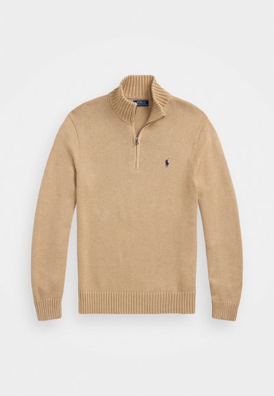Beige zip-up-tröja med ribbad krage och manschetter, strukturerad stickad tyg, med en liten marinblå logotyp på vänster bröst.