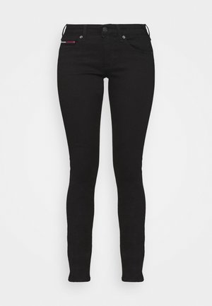 Black skinny jeans made of stretch denim with five pockets, featuring a front button closure and a small red and white logo accent.