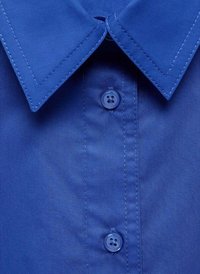 Blue button-up shirt with a pointed collar, featuring a smooth texture, visible stitching, and a button placket with a four-hole button.