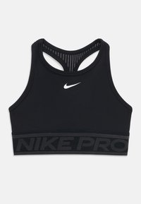 Svart sportsbh med racerback-design, med en hvit Nike-logo og et teksturert svart elastisk bånd merket "NIKE PRO." Glatt materiale.