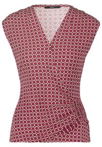Haut rose sans manches avec un motif géométrique en losange, col en V et détail froncé sur le côté droit.