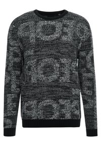 Pull en maille noir et blanc, présentant un motif texturé avec des motifs circulaires éparpillés, un col rond et des poignets côtelés.
