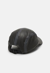 Black cap featuring a sleek design, made of a smooth material with mesh accents, curved brim, and an adjustable strap at the back.