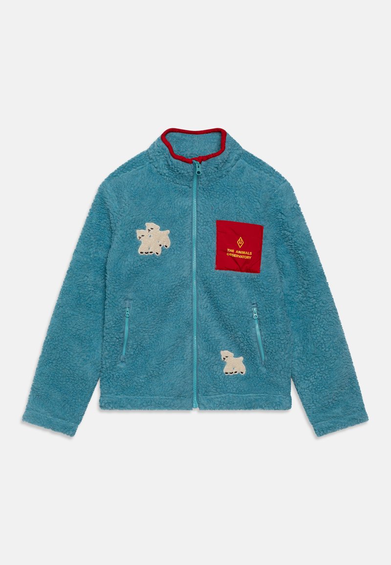 Giacca in pile azzurra chiara con colletto rosso, con zip frontale, due tasche laterali e applicazioni di animali color crema sul petto e sulle maniche.