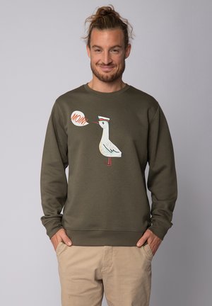 Olive green sweatshirt made of cotton blend, featuring a cartoon bird design with "MOIN" speech bubble in orange. Ribbed cuffs and hem.