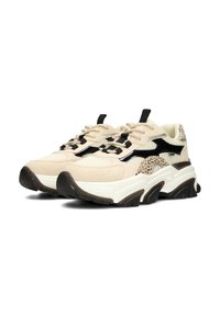 Beige sneakers with black accents and a speckled design, featuring thick soles and lace-up closure, positioned on a white background.