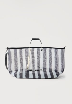 Borsa tote a righe bianche e nere con manico in metallo nero e tracolla removibile, con il marchio "KARL LAGERFELD" sul davanti.