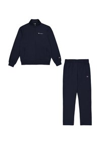 Tuta da ginnastica navy realizzata in tessuto morbido. La giacca presenta un colletto alto e una zip, con tasche frontali. I pantaloni hanno una vita elastica e tasche laterali.