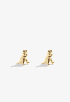 Boucles d’oreilles clous en forme de dinosaure ton or avec petites pierres claires pour les yeux sur fond blanc uni.