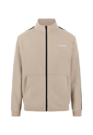Veste zippée beige en mélange de coton. Dotée de rayures noires sur les côtés, de deux poches avant et d'un col haut avec un logo brodé.