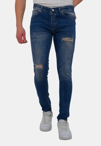 Blauwe denim jeans met een slim fit, voorzien van versleten accenten op de knieën, een klassieke vijf-pocket stijl en een lichte versleten wassing.