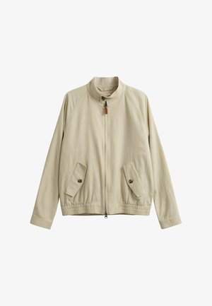 Veste zippée beige avec col montant, deux poches avant à boutons et ourlet élastique, présentée sur un fond blanc.