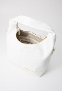 White leather handbag with a textured surface, gold zipper, and interior pockets. The bag has a short handle and stitched details.