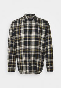 Svart, vit och gul rutig flanellskjorta med knappkrage och långa ärmar, med rak fåll och trärknappar.