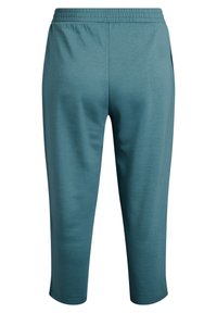 Pantalons de sport turquoise en tissu léger et respirant. Dotés d'une taille élastique, de jambes fuselées et sans motifs ni matériel visible.