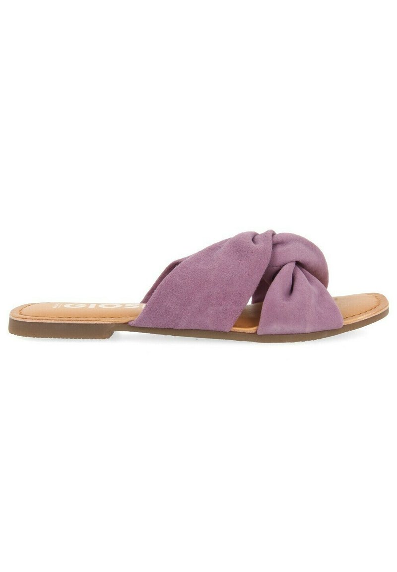 Sandali slip-on in suede viola con design annodato, soletta color nocciola e suola piatta in gomma. Nessun abbellimento o hardware visibile.