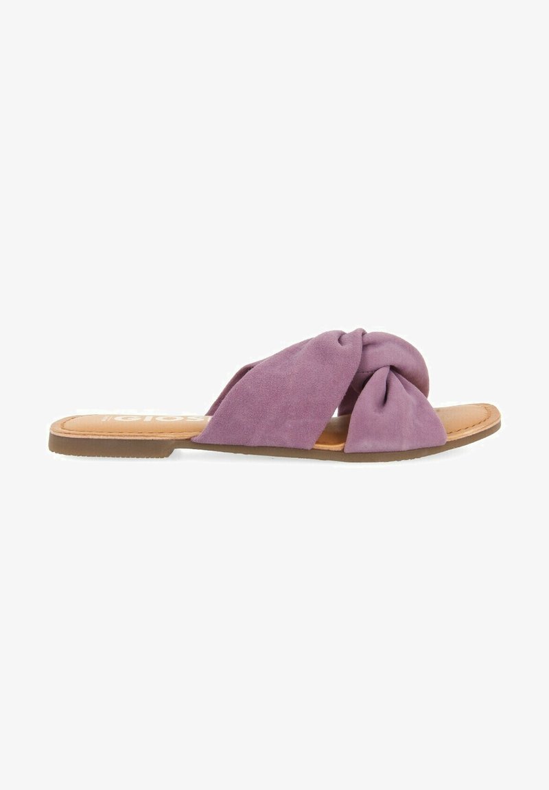 Sandali slip-on in suede viola con design annodato, soletta color nocciola e suola piatta in gomma. Nessun abbellimento o hardware visibile.