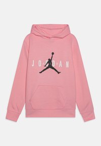 Różowa bluza z kapturem wykonana z miękkiego materiału, z dużym czarnym logo "Jumpman" oraz napisem "JORDAN". Posiada kieszeń z przodu oraz ściągacze przy mankietach.