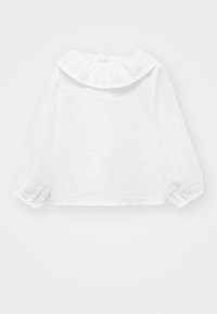 Blusa bianca a maniche lunghe realizzata in tessuto testurizzato, con scollatura arricciata e polsini raccolti, dal design cropped.