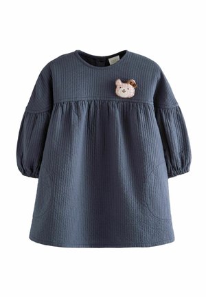 Robe matelassée bleu foncé pour tout-petit avec de longues manches bouffantes et une petite appliqué visage d'ours avec un nœud sur la poitrine.