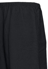 Pantalon noir ample avec taille élastique et poche latérale visible sur fond blanc.