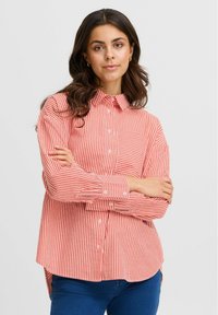 Red and white striped button-up shirt with a collar and single chest pocket; soft fabric; long sleeves with buttoned cuffs; relaxed fit.