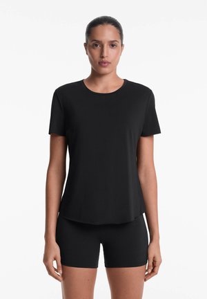 Black short-sleeve T-shirt featuring a round neckline and a relaxed fit, paired with matching black shorts, made from a smooth, stretchy fabric.