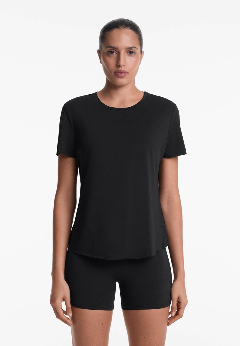 Black short-sleeve T-shirt featuring a round neckline and a relaxed fit, paired with matching black shorts, made from a smooth, stretchy fabric.