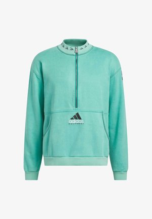 Turkoosi huppari korkealla kauluksella, puolivetoketjulla edessä ja mustalla Adidas-logolla. Sisältää kengurupocketin ja ribbarikäänteet. Pehmeä rakenne.