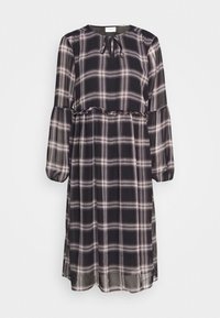 Musta ruudullinen mekko pitkillä hihoilla, pyöreällä kaula-aukolla, röyhelökoristelu vyötäröllä ja kevyestä, läpikuultavasta kankaasta.