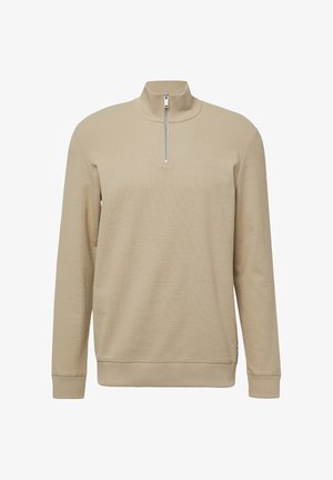 Beżowy pulower z ćwierć zamkiem, wykonany z teksturowanej tkaniny. Posiada żeberkowy kołnierz i mankiety, z małym logo z przodu. Miękki i ciepły design.