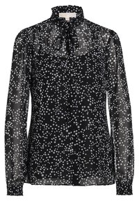 Blouse noire transparente à manches longues avec motif d'étoiles blanches, col haut volanté et nœud papillon au niveau de l'encolure.