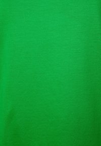 Green cotton t-shirt with a smooth texture, solid color, and short sleeves. The fabric is lightweight and has a subtle, even weave.
