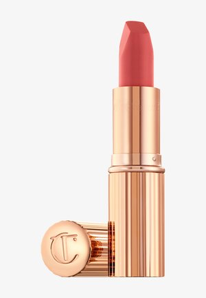 Lipstick in a gold-toned, ribbed case. The bullet is a soft coral-pink with a unique angular shape and embossed logo on the cap.