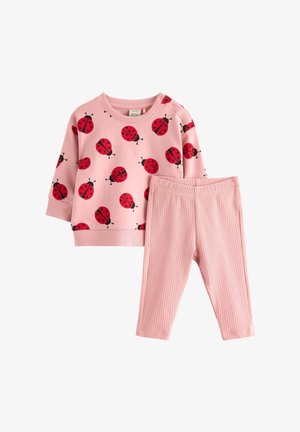 Completo rosa per bambina con maglietta a maniche lunghe decorata con stampe di coccinelle rosse e leggings a coste coordinati.
