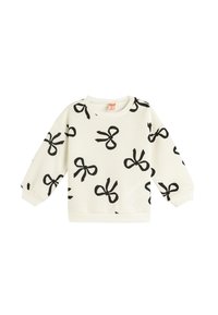 Sweatshirt blanc avec imprimé nœud noir, texture côtelée, col rond et manches longues. Dispose de poignets et d'une taille élastiques.