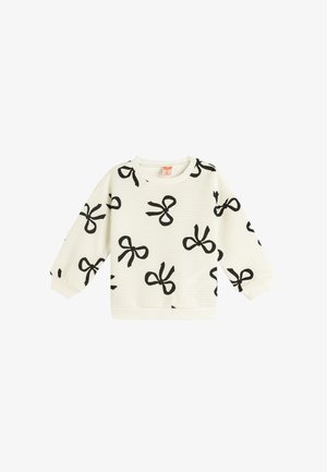 Sweatshirt blanc avec imprimé nœud noir, texture côtelée, col rond et manches longues. Dispose de poignets et d'une taille élastiques.
