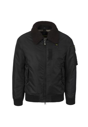 Black bomber jacket with a faux fur collar, zip closure, side pockets, ribbed cuffs, and patch detail on the sleeve.