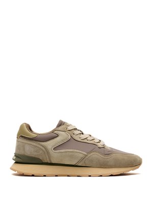 Low-top sneaker in beige and taupe with suede and fabric panels, lace-up front, and a beige rubber sole.