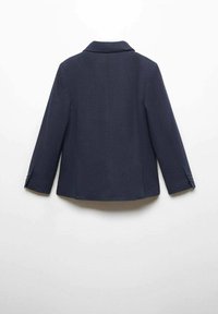 Námořnický blazer s klasickým límcem, dlouhými rukávy a manžetami na dva knoflíky. Texturovaná látka s přiléhavým střihem a rovný lem.