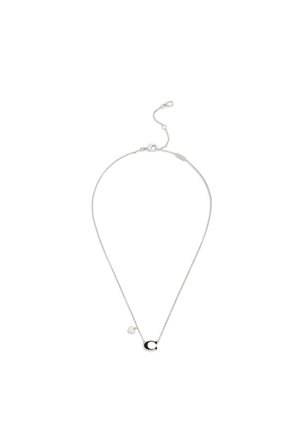 Silberne Kettenhalskette mit einem schwarzen und silbernen "C"-Anhänger und einem kleinen Herzanhänger nahe dem Verschluss vor weißem Hintergrund.