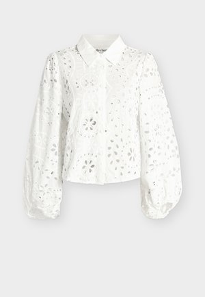 Λευκό μπλούζα με μακριά μανίκια και κουμπιά, με κεντήματα floral cut-out και φουσκωτά μανίκια, με κλασικό γιακά και ελαστικά μανσέτες.