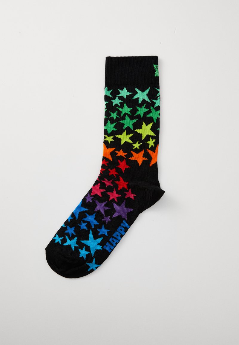 Black socks with a gradient of colorful star patterns in green, orange, red, and blue. Features "HAPPY" text in blue at the toe.