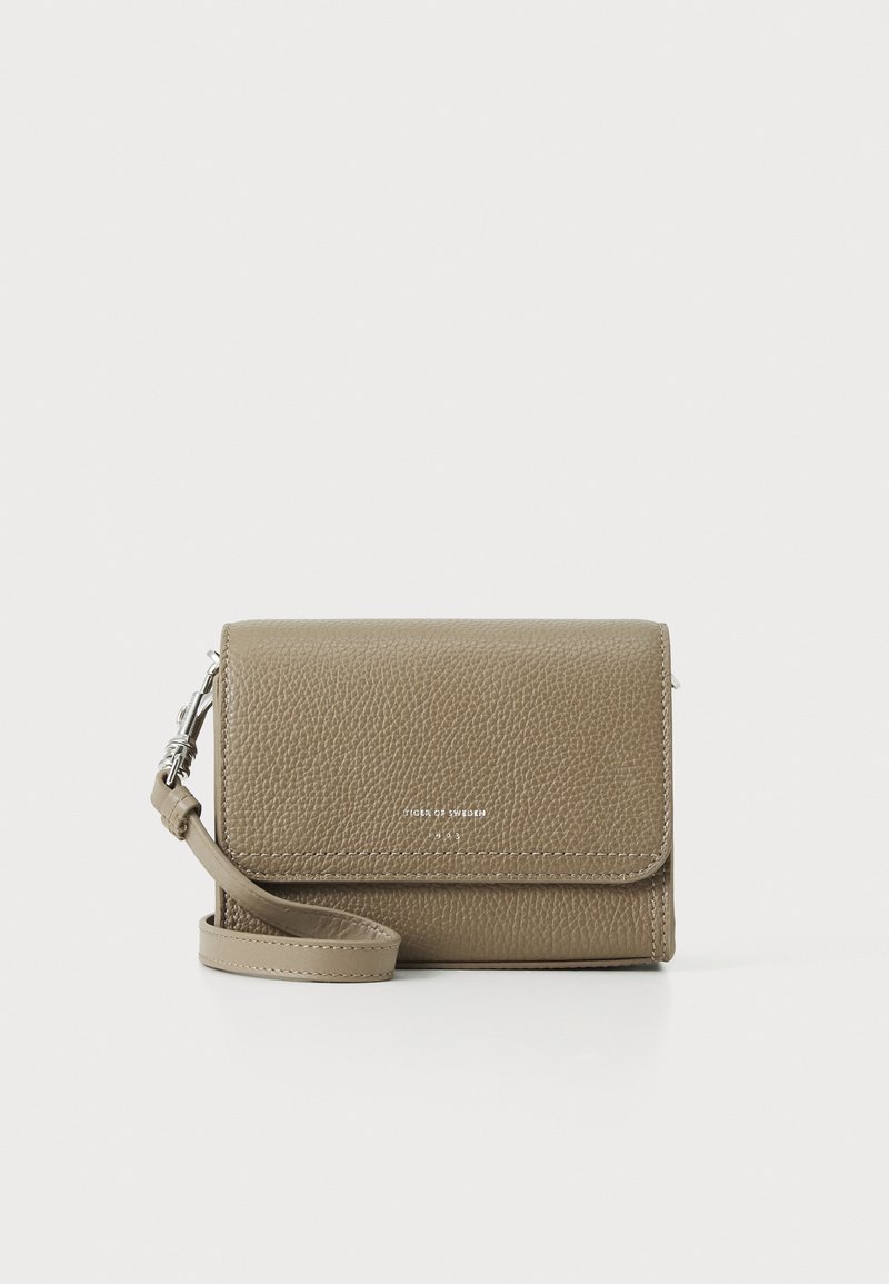 Grey leather crossbody bag with a structured design, a detachable strap, and a subtle logo embossed on the front. Textured surface.