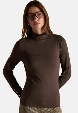 Brown long-sleeve top with a ruffled high neck, textured fabric, and button accents on sleeves. Fitted design.