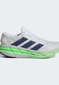 White textured running shoe with navy stripes, a green sole, and reflective accents. Lightweight fabric upper for breathability.