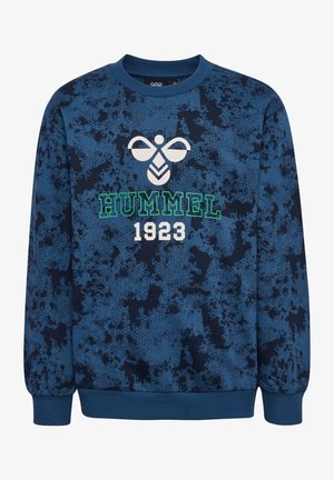 Sweatshirt bleu avec un motif texturé, arborant un logo blanc et l'inscription "HUMMEL 1923" en lettres vertes et blanches. Poignets et col côtelés.