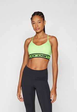 Neon green sports bra with a scoop neckline, thin straps, and a black elastic band featuring "Jordan" logo. Paired with black leggings.