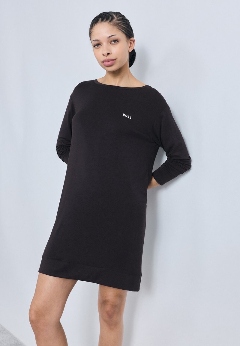 Black pullover dress with a round neckline and long sleeves. Features a small white "BOSS" logo on the chest. Soft, stretchy fabric.